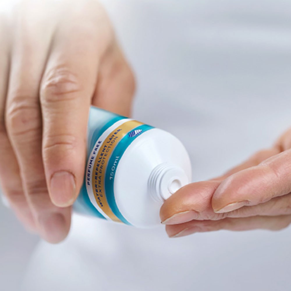 Hands squeezing skin cream from a tube. Hands squeezing skin cream from a tube.